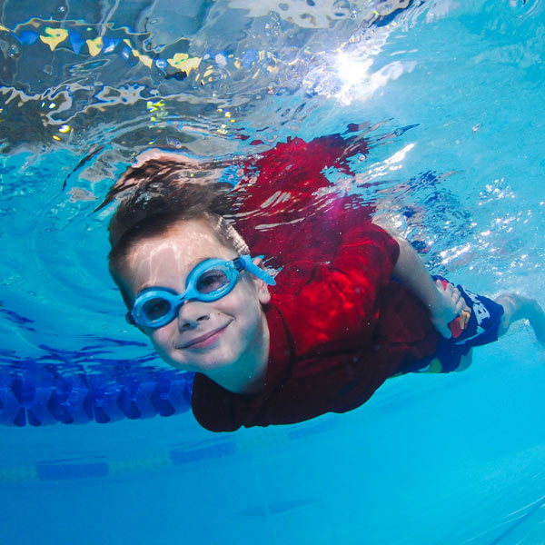 boy swimming under water